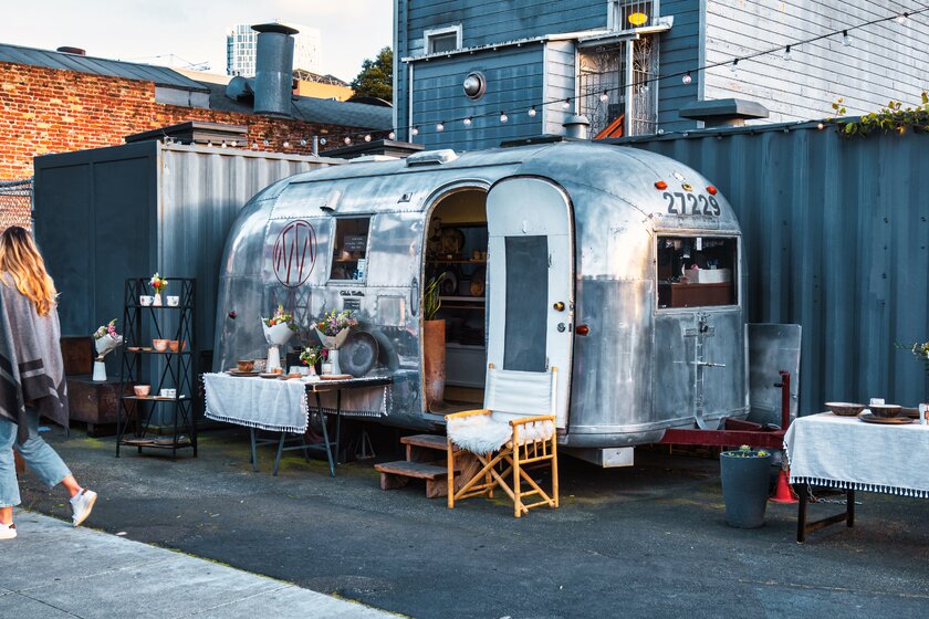 A rounded metal American trailer is used as an outdoor store on a downtown sidewalk in San Francisco.