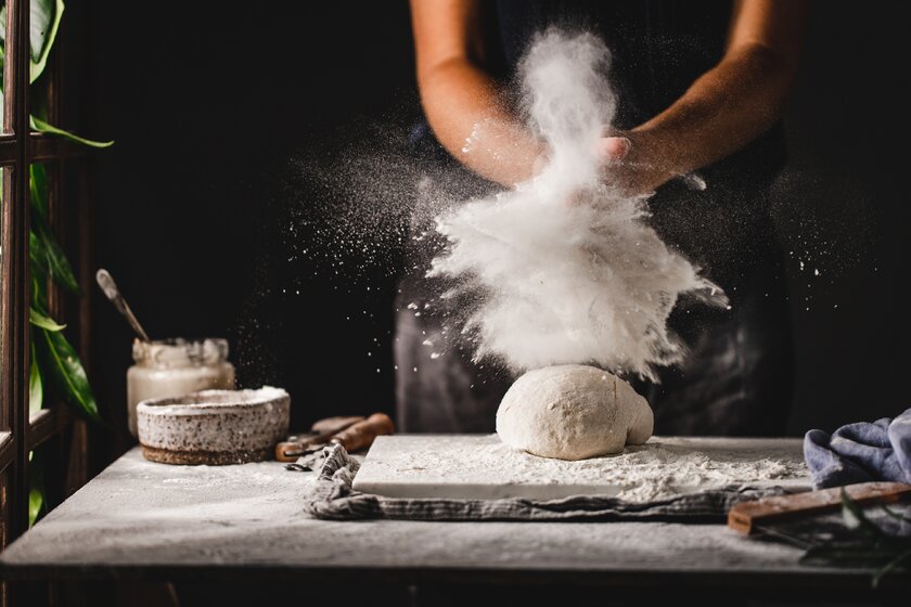 Female hands preparing sourdough bread in the kitchen.