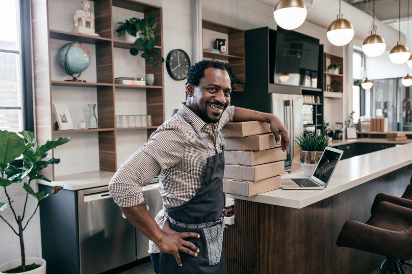 A smiling small business owner in his store.