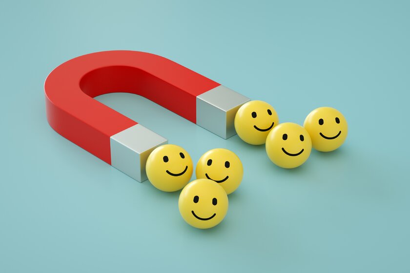 3D-Darstellung eines Magneten, der Smiley-Emojis anzieht.