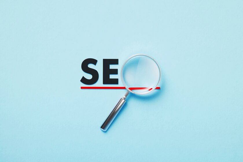 Magnifying glass forming SEO word.