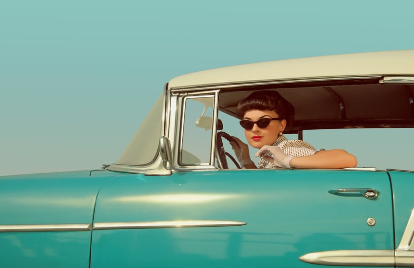 Woman with Sunglasses driving her Cadillac.