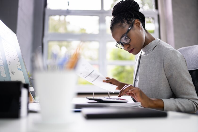 Female entrepreneur comparing financial products at her desk.