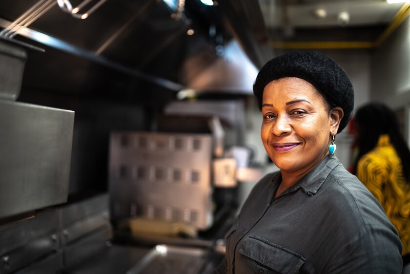 Portrait of a mature woman in her franchise kitchen.