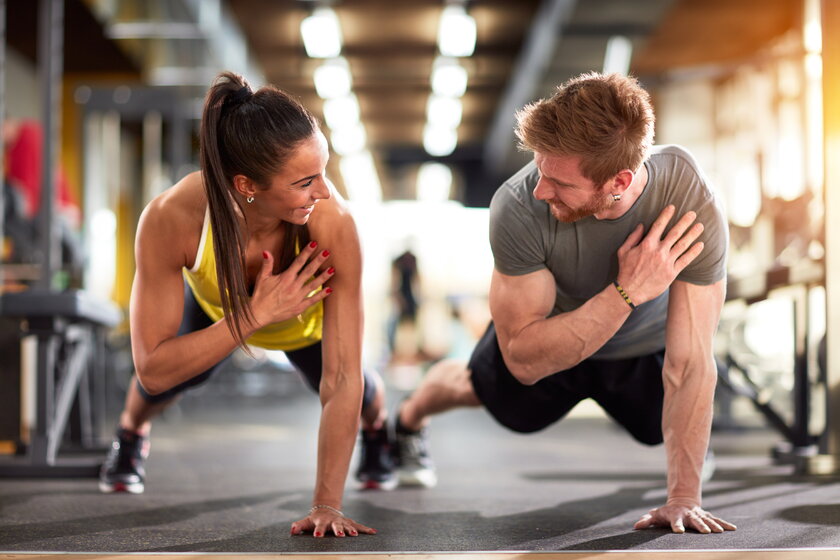 A man and a woman strengthen hands at fitness training.