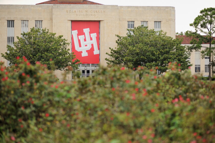 University of Houston building with large sign and initials