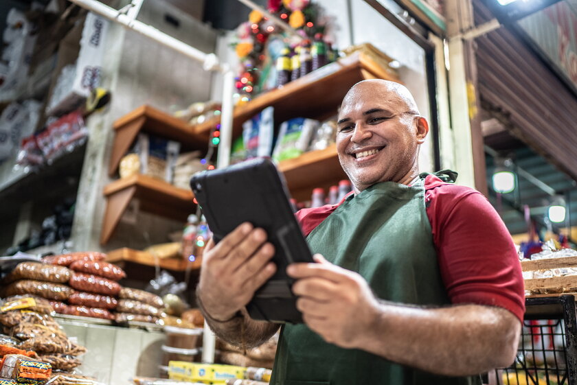 Mature man small business owner with digital tablet.