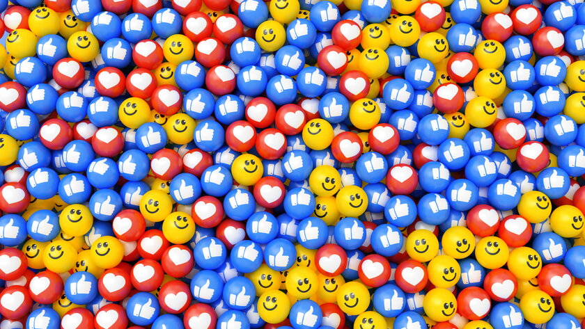 Multicolored balls with smile, heart and thumbs up symbols.