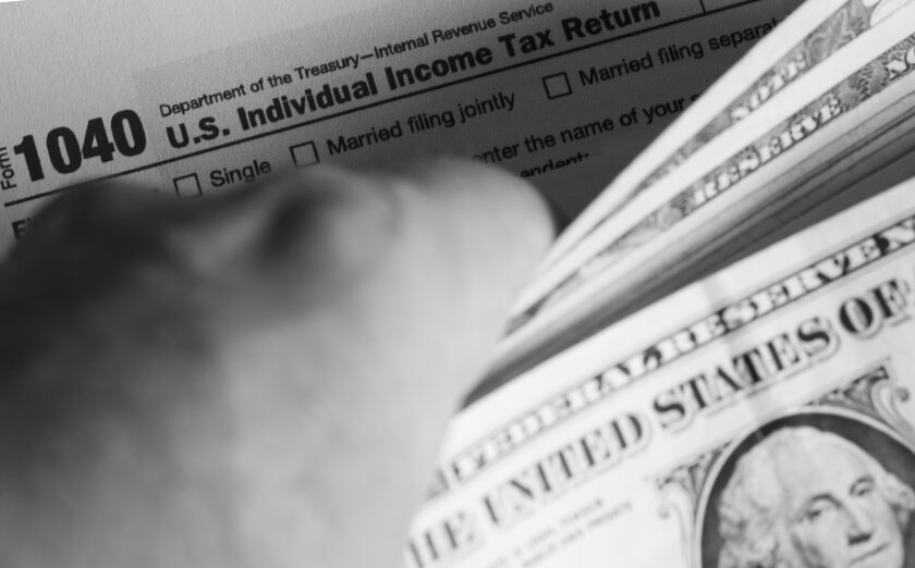 Tax Filing Form 1040 and Dollar Bills