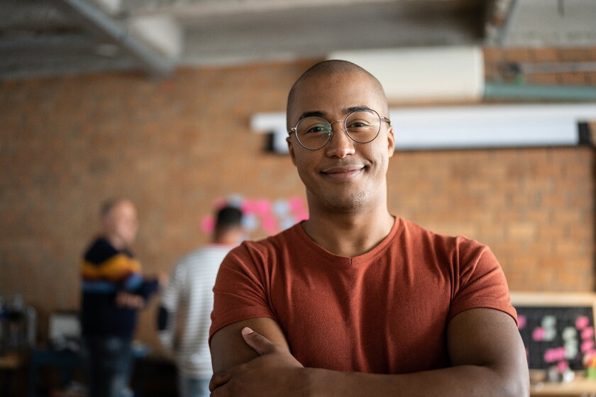 Portrait of a cheerful young man with smart glasses at work.