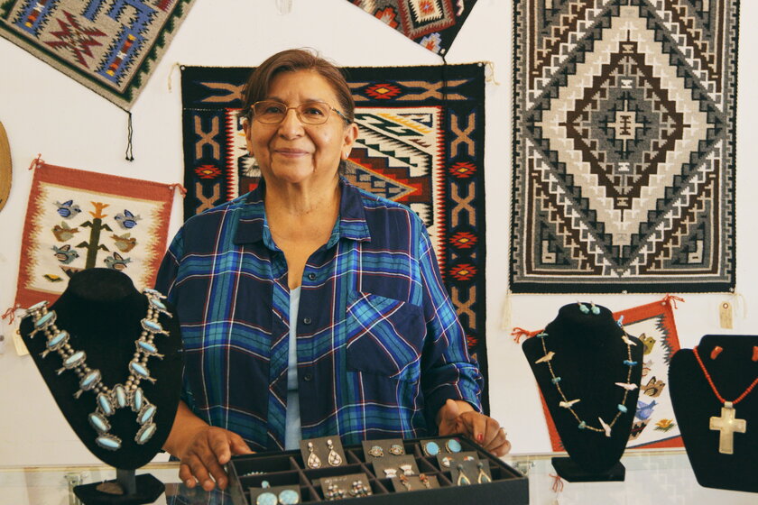 A Navajo entrepreneur stands in her jewelry store.